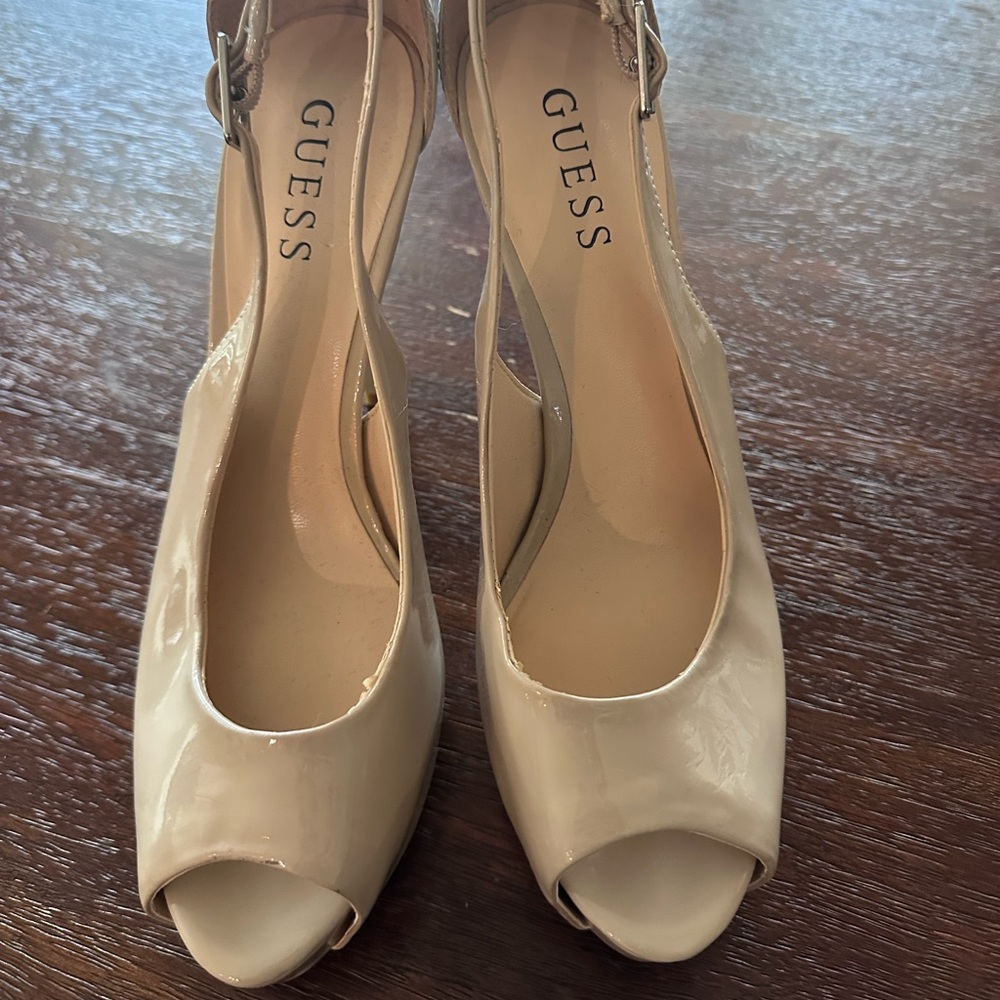 Guess women’s peep toe nude patent leather heels.